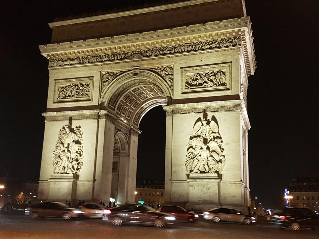 Arc de Triomphe- Napoleon’s dream, glowing against the Parisian night.