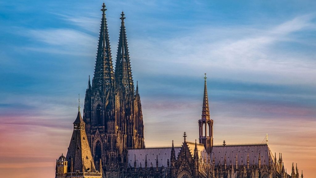 Cologne Cathedral's twin spires against twilight sky—a landmark for student travellers.
