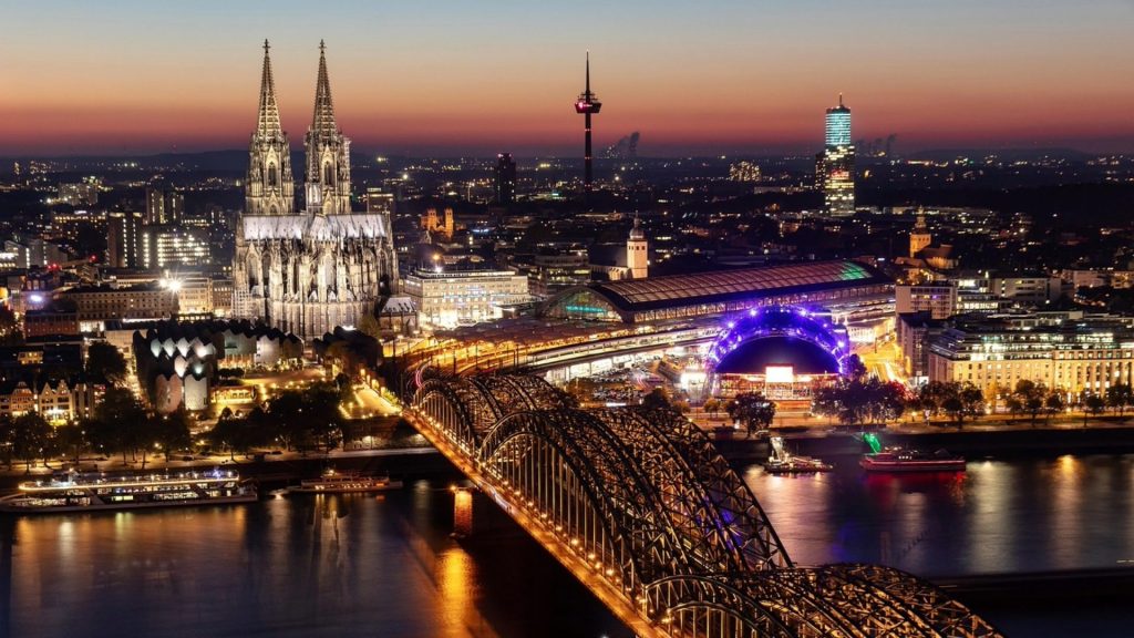 Cologne cityscape at dusk with cathedral and Rhine River—photography students' paradise.