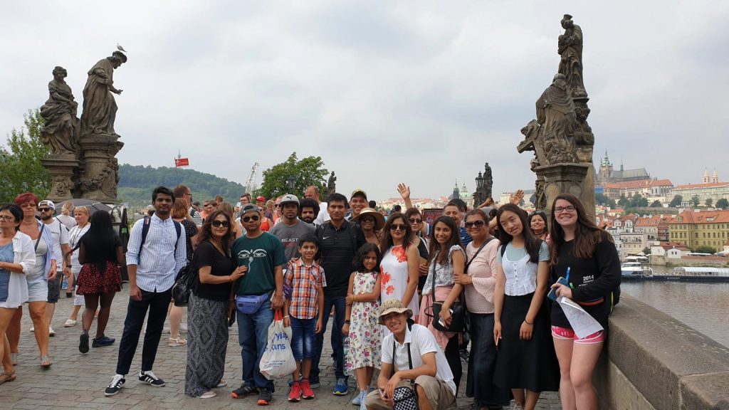 Student tour group posing on Prague's Charles Bridge.