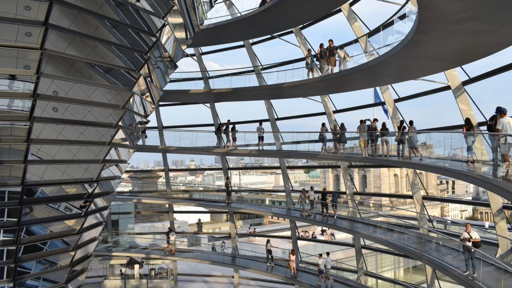 Inside the Reichstag dome, where study trip visitors explore German parliamentary architecture.